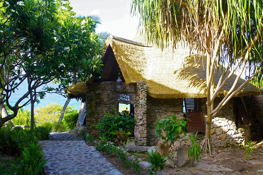 brick building with cape reed thatched roof